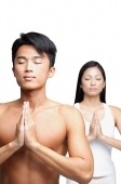 Couple doing yoga, man in front, woman standing behind him - Asia Images Group