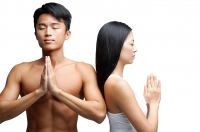 Couple doing yoga, side by side, man facing camera, woman facing away - Asia Images Group