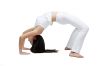 Woman doing yoga, bridge position - Asia Images Group