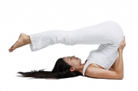 Woman doing yoga, shoulder stand position - Asia Images Group