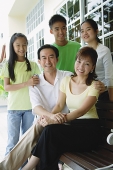 Parents with three children, smiling at camera - Asia Images Group