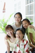 Family of females looking at camera, smiling - Asia Images Group