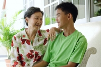Grandmother and grandson looking at each other smiling - Asia Images Group