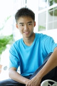 Teenaged boy looking at camera, smiling - Asia Images Group
