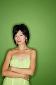 Woman in green dress, arms crossed - Asia Images Group