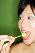 Woman with lollipop in mouth - Asia Images Group