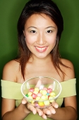 Woman with a bowl of candy - Asia Images Group