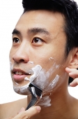 Man shaving face - Asia Images Group