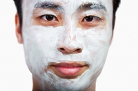 Man with face mask looking at camera - Asia Images Group