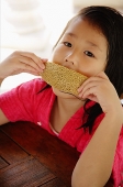 Girl eating bread - Asia Images Group