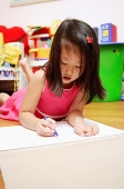 Young girl on floor drawing - Asia Images Group
