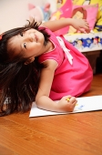 Young girl on floor, looking at camera - Asia Images Group