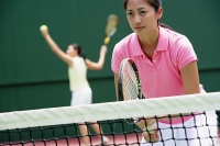 Women with tennis rackets, playing tennis - Asia Images Group