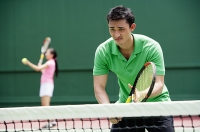 Couple playing tennis - Asia Images Group