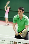 Couple playing tennis, mixed doubles - Asia Images Group