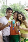 Young adults holding cocktails, looking at camera - Asia Images Group