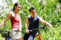 Couple with bicycles in park - Asia Images Group