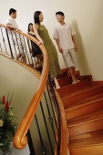 Young adults walking down stairs - Asia Images Group