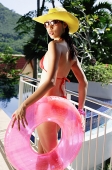 Woman in red bikini and hat, holding inflatable ring - Asia Images Group