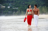 Couple walking side by side along beach - Asia Images Group