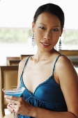 Woman holding drink, looking at camera - Asia Images Group