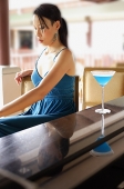 Woman sitting at bar counter - Asia Images Group