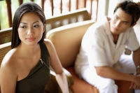 Woman looking away, man next to her, looking at her - Asia Images Group