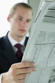 Businessman reading newspaper - Asia Images Group