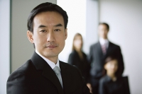 Businessman, portrait, people in the background - Asia Images Group