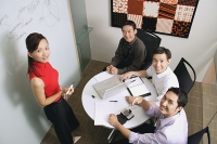 Executives in meeting room, looking up at camera - Asia Images Group