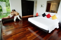 Couple in bedroom, sitting on daybed - Asia Images Group