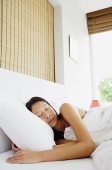 Woman sleeping in bed - Asia Images Group