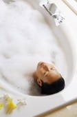 Woman in bathtub, eyes closed, high angle view - Asia Images Group