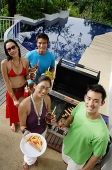 Couples at barbeque party, smiling at camera, portrait - Asia Images Group