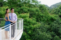 Couple standing on balcony, looking away - Asia Images Group