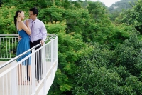 Couple standing on balcony, embracing - Asia Images Group