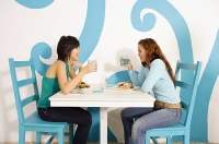 Young women having lunch in cafe - Asia Images Group