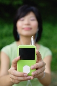 Young woman with mp3 player, eyes closed - Asia Images Group