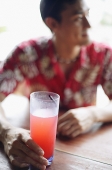 Man with drink, selective focus - Asia Images Group
