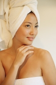 Woman wearing a towel, looking away, smiling - Asia Images Group
