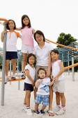Siblings at playground, smiling at camera - Asia Images Group