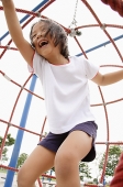 Girl on jungle gym, laughing - Asia Images Group