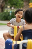 Two girls on a seesaw, face to face - Asia Images Group