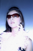 Woman with sunglasses and feather boa - Asia Images Group