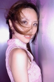 Woman in cheongsam top, looking at camera - Asia Images Group