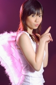 Young woman wearing angel wings, looking at camera - Asia Images Group