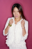 Young woman in white outfit, hands in fists, looking at camera - Asia Images Group