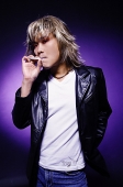 Man in leather jacket, smoking - Asia Images Group
