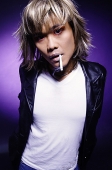 Man in leather jacket, cigarette in mouth, looking at camera - Asia Images Group