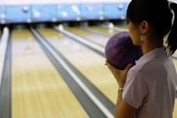 Woman preparing to bowl, over the shoulder view - Asia Images Group